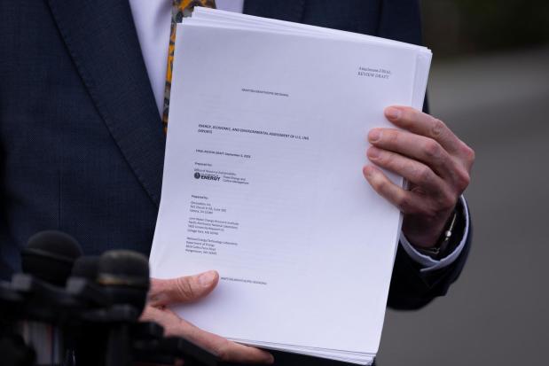 FILEL - Energy Secretary Chris Wright holds a report concerning U.S. exports of liquefied natural gas (LNG) as he speaks to reporters at the White House in Washington, on March 19, 2025. (AP Photo/Ben Curtis, File)