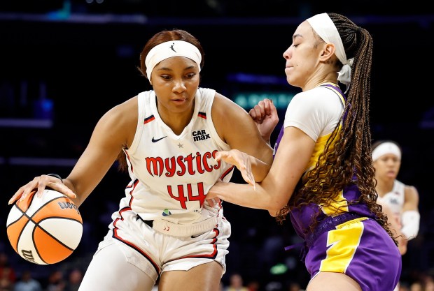 Washington's Kiki Iriafen drives against the Sparks' Dearica Hamby in the first half Tuesday, July 15, 2025, at Crypto.com Arena. (Photo by Ronald Martinez/Getty Images)