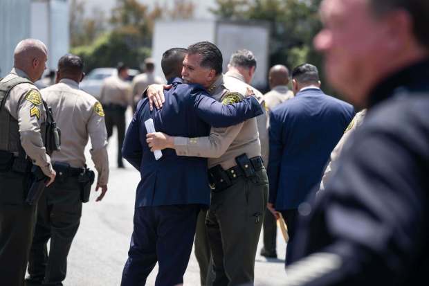 Los Angeles County Sheriff Robert Luna is hugged after three deputies were killed following an explosion at the Los Angeles County Sheriff's training facility in East Los Angeles on Friday, July 18, 2025 after leaving a press conference. (Photo by Sarah Reingewirtz, Los Angeles Daily News/SCNG)