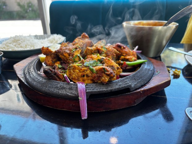 Daddy Ji's Achari Chicken Tikka arrives on a sizzling hot plate packed with spice and flavor. (Emily St. Martin)