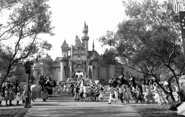 In this Sunday, July 17, 1955 file photo, children sprint across a drawbridge and into a castle that marks the entrance to Fantasyland at the opening of Walt Disney's Disneyland in Anaheim, Calif. (AP Photo)