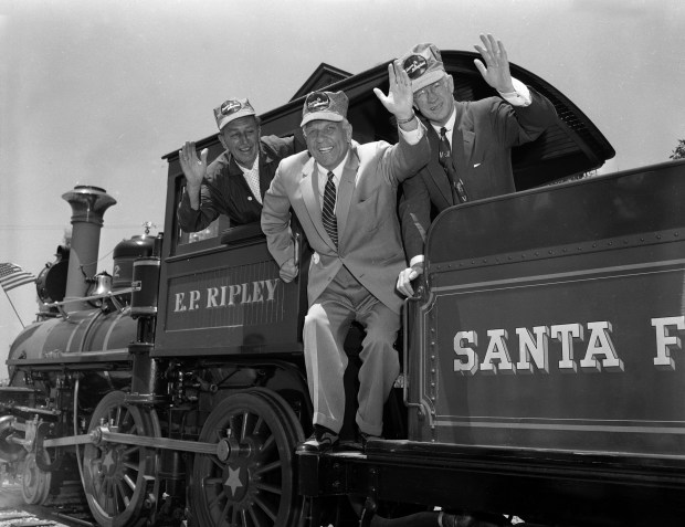 From left, Walt Disney, California Gov. Goodwin J. Knight and Fred G. Gurley, president of Santa Fe Railroad, are shown aboard the Disneyland Railroad on the park's opening day, July 17, 1955. (The Associated Press)
