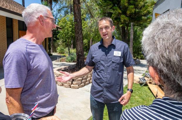 Bryan Crain, center, President and CEO of the Orange County Rescue Mission, speaks with attendees following the ribbon cutting ceremony at the Double R Ranch for the newly renovated women's housing in Silverado on Thursday, June 19, 2025. (Photo by Mark Rightmire, Orange County Register/SCNG)