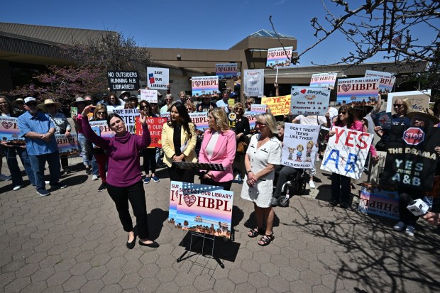 Lindsay Klick, Orange County Librarian, left, joins Patricia Singer, President of the Ocean View School District Board of Trustees, Gina Clayton-Tarvin, Ocean View School District Trustee, and Diana Marks, President of the Huntington Beach City School District Board of Trustees, right, during a press conference held by supporters of two ballot initiatives going before voters on June 10 concerning Huntington Beach's libraries on Tuesday, April 8, 2024 in Huntington Beach CA. (Photo by Jeff Gritchen, Orange County Register/SCNG)