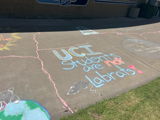 Activists like UC Irvine alumni Kevin Li, wrote messages and drew pictures opposing a SoCalGas headed hydrogen-blending project in chalk outside of a public hearing with the California Public Utilities Commission. The project will move onto an evidentiary hearing after the hearings. (Photo by Emilie Takahashi/SCNG)