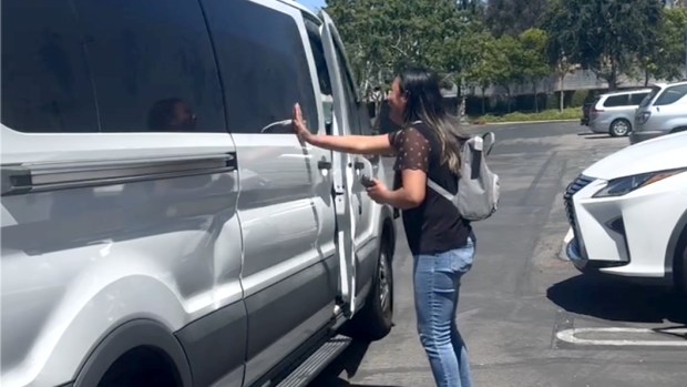 A woman cries out for her friend, who she says is an asylum seeker from Guatamala, and was placed inside a van that will transport her and another man to a facility for deportation processing. (Photo by Mona Darwish)