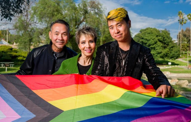 Vietnamese-American musician Duy Nguyen-Amigo, 29, right, with his parents Hung, left, and Thuy Nguyen at Eisenhower Park in Orange. It has been more than 10 years since Nguyen-Amigo came out to his parents that he was gay. They did not take the news well. Like many in the Vietnamese-American community they were not accepting of the LGBTQ+ community. Now his relationship with them is strong. "The coming out process was not just for me, but also for them, too," Nguyen-Amigo said. "It's a learning experience that took some time. They slowly but surely came around."(Photo by Leonard Ortiz, Orange County Register/SCNG)