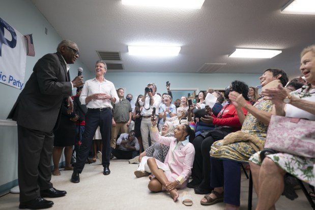 Rep. James Clyburn (D-SC) (L) gets a response after intimating that California Gov. Gavin Newsom (C, left) is campaigning for president at the Kershaw County Center on July 8, 2025 in Camden, South Carolina. The governor is on the first of a two-day tour of rural counties in South Carolina, hosted by the state Democratic Party. (Photo by Sean Rayford/Getty Images)