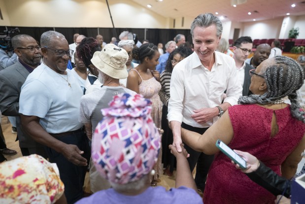 California Gov. Gavin Newsom shakes hands with attendees at Fisher Hill Community Baptist Church on July 8, 2025 in Cheraw, South Carolina. The governor is on a two-day tour of rural counties in South Carolina, hosted by the state Democratic Party. (Photo by Sean Rayford/Getty Images)