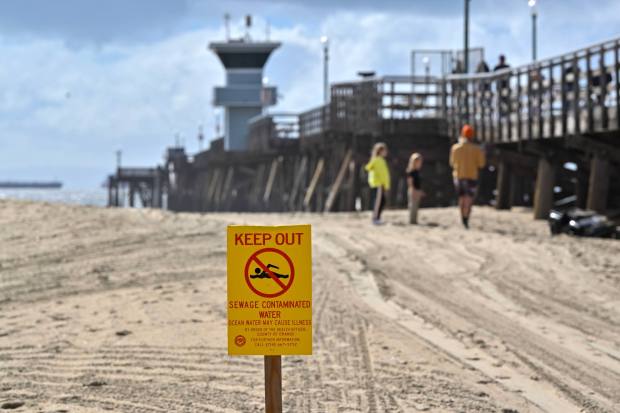 A sign warns beachgoers not to enter the water during to a sewage spill in Seal Beach, CA, on Wednesday, Feb. 7, 2024. (Photo by Jeff Gritchen, Orange County Register/SCNG)
