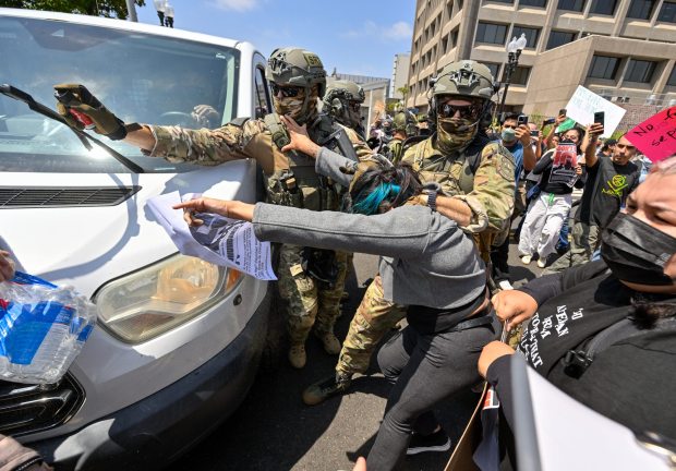 Police use pepper spray as they move protesters away from a van leaving the Federal Building in Santa Ana, CA, on Monday, June 9, 2025. About 200 anti-ICE protesters spent the afternoon carrying signs as they chanted and yelled at police. (Photo by Jeff Gritchen, Orange County Register/SCNG)