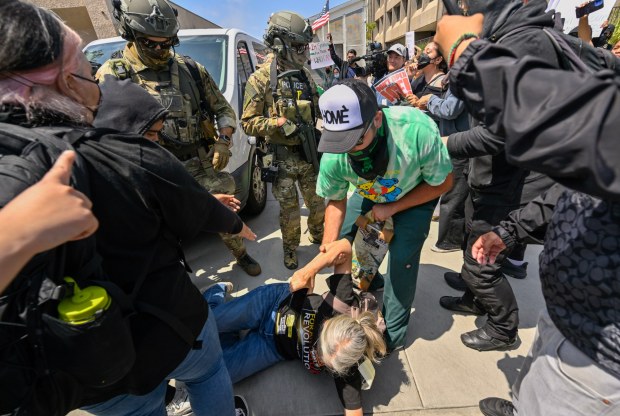 Police move protesters away from a van leaving the Federal Building in Santa Ana, CA, on Monday, June 9, 2025. About 200 anti-ICE protesters spent the afternoon carrying signs as they chanted and yelled at police. (Photo by Jeff Gritchen, Orange County Register/SCNG)