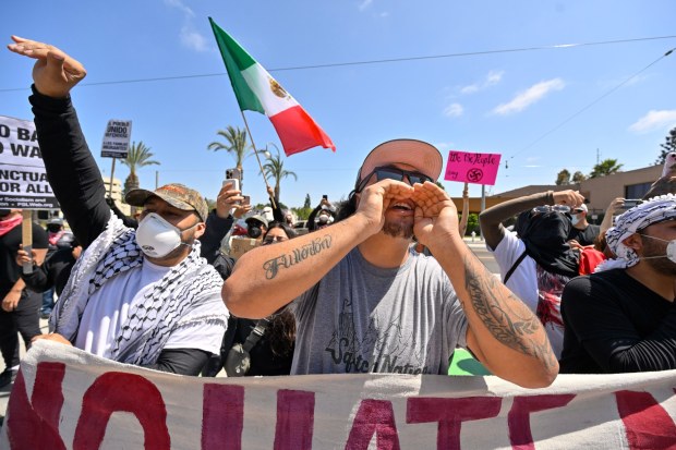 Protesters yell at police as they block the driveway to the Federal Building while police stand guard in Santa Ana, CA, on Monday, June 9, 2025. About 200 anti-ICE protesters spent the afternoon carrying signs as they chanted and yelled at police. (Photo by Jeff Gritchen, Orange County Register/SCNG)