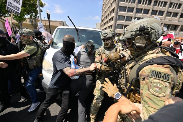 Police move protesters away from a van leaving the Federal Building in Santa Ana, CA, on Monday, June 9, 2025. About 200 anti-ICE protesters spent the afternoon carrying signs as they chanted and yelled at police. (Photo by Jeff Gritchen, Orange County Register/SCNG)