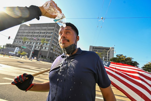 A protester washes his face after police used tear gas and flash-bangs at the Federal Building in Santa Ana, CA, on Monday, June 9, 2025. About 400 anti-ICE protesters spent the afternoon carrying signs as they chanted and yelled at police. (Photo by Jeff Gritchen, Orange County Register/SCNG)