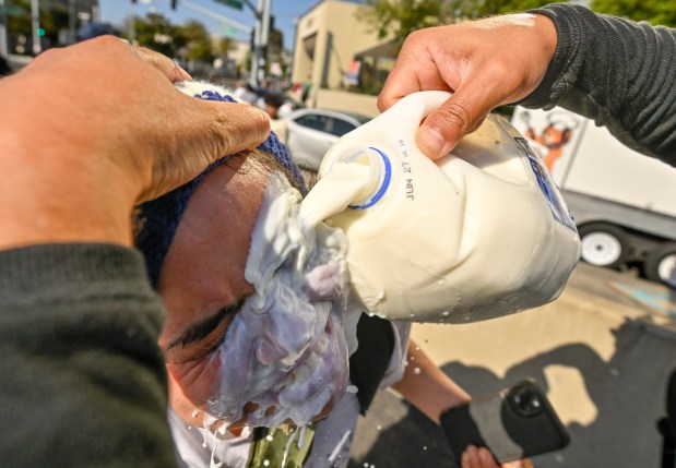 A protester washes his face after police used tear gas and flash-bangs at the Federal Building in Santa Ana, CA, on Monday, June 9, 2025. About 400 anti-ICE protesters spent the afternoon carrying signs as they chanted and yelled at police. (Photo by Jeff Gritchen, Orange County Register/SCNG)