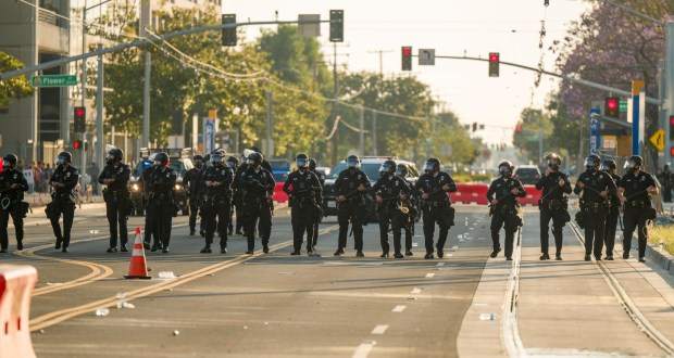 Santa Ana Police march down Santa Ana Boulevard after declaring a riot after protesters against ICE began clashing with federal police outside the Federal Building in downtown in Santa Ana on Monday, June 9, 2025. (Photo by Leonard Ortiz, Orange County Register/SCNG)