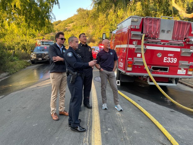 Laguna Beach Mayor Alex Rounaghi, left, Laguna Beach Fire Chief Niko King, Laguna Beach Police Chief Jeff Calvert and City Manager Dave Kiff, watch the fire in Bluebird Canyon on Monday, July 7. (Photo courtesy of Alex Rounaghi)