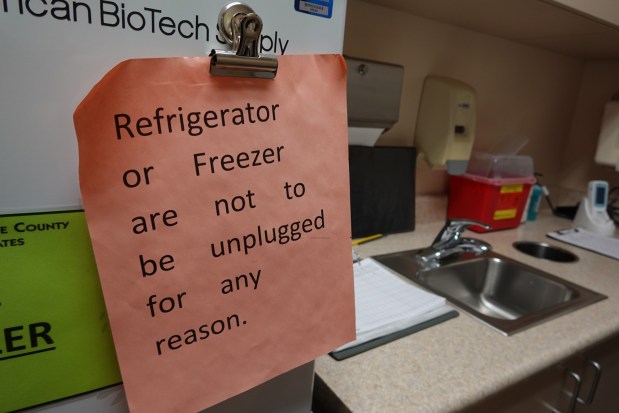 An unplugged refrigerator could spoil the vaccines inside, costing the practice thousands of dollars. (Jackie Fortiér/KFF Health News)