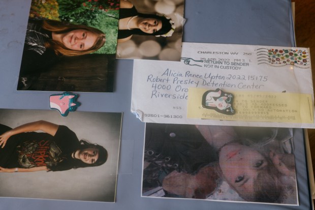 Childhood photos of Alicia Upton and a letter, addressed to her in jail, that never reached her and was returned to her mother.(Kristian Thacker for The New York Times)