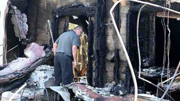 Andres Psaras walks through the rubble of the Riverside home he purchased for his daughter and husband that was destroyed by the Hawarden fire in July 2024. Fire officials said teens playing with illegal fireworks caused the blaze that leveled seven homes. (Photo by Will Lester, Inland Valley Daily Bulletin/SCNG)
