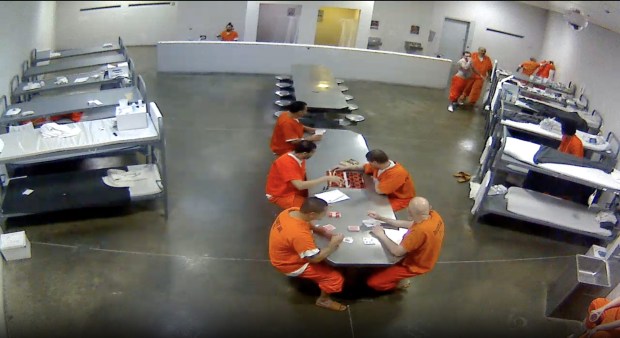 A moment from the attack on Rosendo Echevarria, top right, while others played cards and chess nearby. (Riverside County Sheriff's Department)