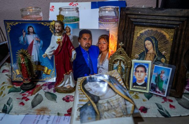 Maria Murillo, wife of ICE detainee Jose Luis Zavala has their wedding photo at an alter in the living room of the family home with a candle burning in Pomona on Thursday, July 17, 2025. (Photo by Terry Pierson, The Press-Enterprise/SCNG)
