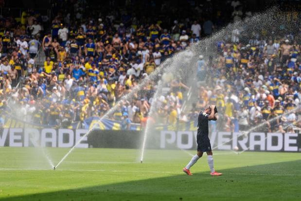 FILE - Auckland City's Gerard Garriga cools off under the sprinklers during a water break in the Club World Cup Group C soccer match between Auckland City and Boca Juniors in Nashville, Tenn., Tuesday, June 24, 2025. (AP Photo/George Walker IV, File)