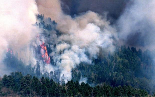FIRE - The Cerro Grande fire burns above Los Alamos, N.M., near the Los Alamos National Laboratory, May 10, 2000. (AP Photo/Sarah Martone, File)